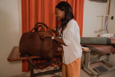 A light tan leather duffle bag - 2 Short straps within custom made realization
