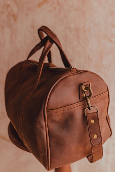 A light tan leather duffle bag - 2 Short straps