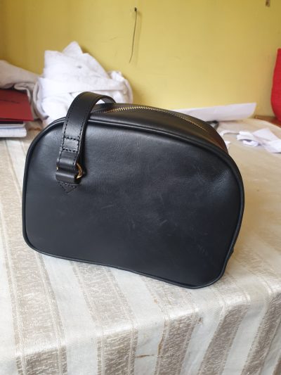 Tailor-made small black leather handbag within custom made realization