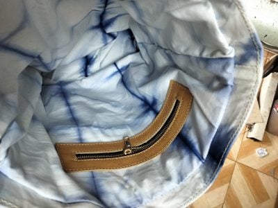 Custom made tie-dye fabric bag with brown leather straps within custom made realization