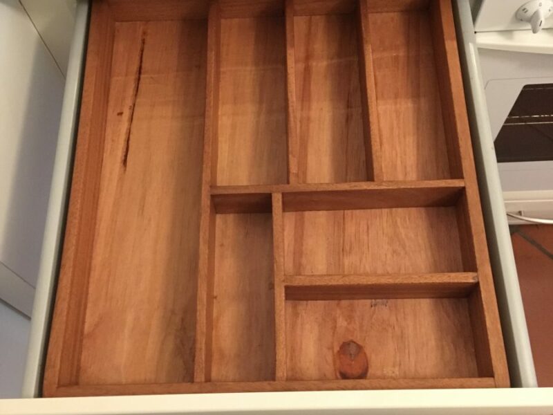 Cutlery tray of wood for a kitchen drawer