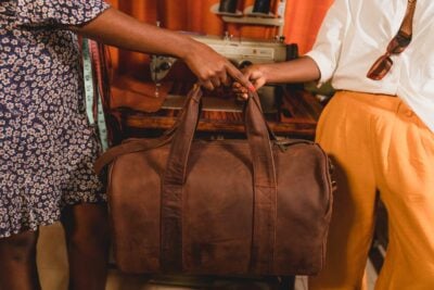 A light tan leather duffle bag - 2 Short straps within custom made realization